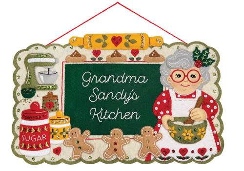 Personalized Christmas baking felt wall hanging kit featuring a cheerful baker, gingerbread cookies, mixer, rolling pin, sugar canister, holly, sequins, beads, and a custom center message.