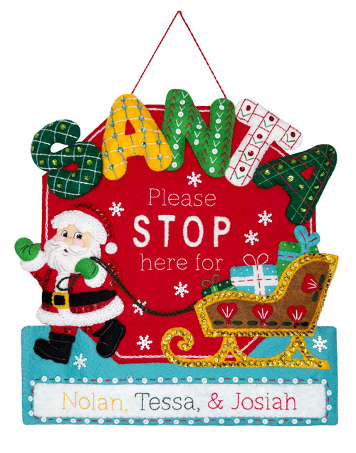 Santa Stop Here personalized felt wall hanging featuring Santa pulling his sleigh with oversized SANTA lettering and custom family names.