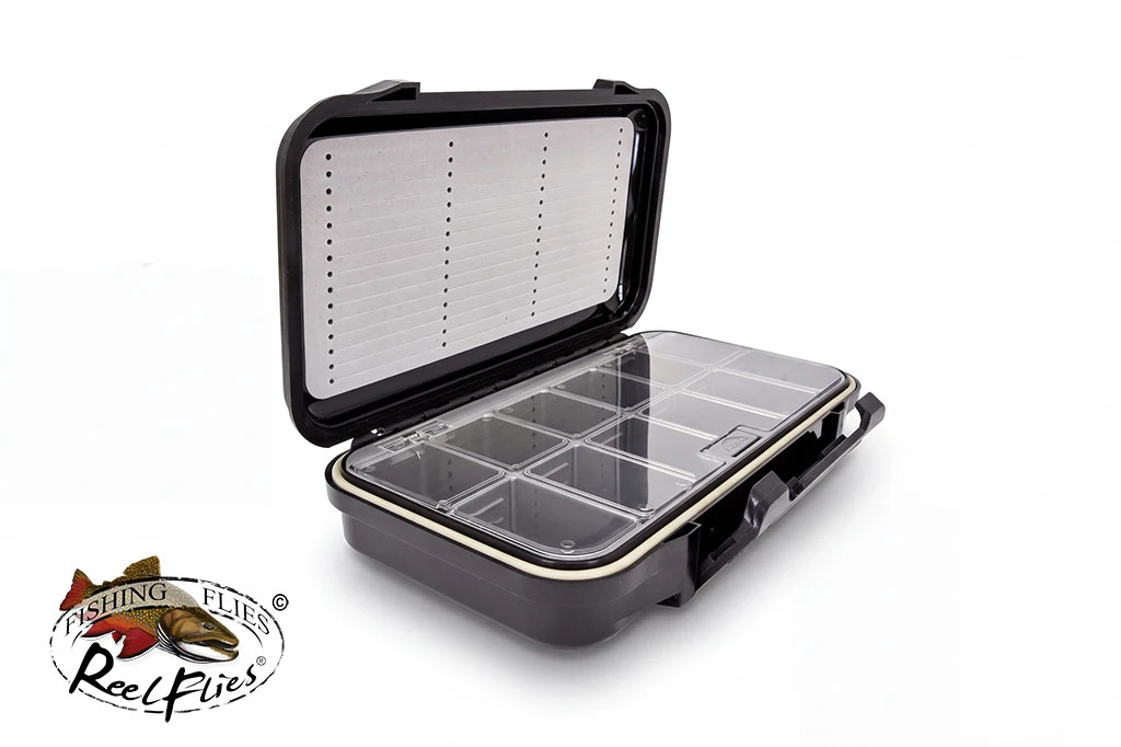 ReelFlies combination fly box open at an angle, showing slotted foam and 12 compartments beneath a clear lid