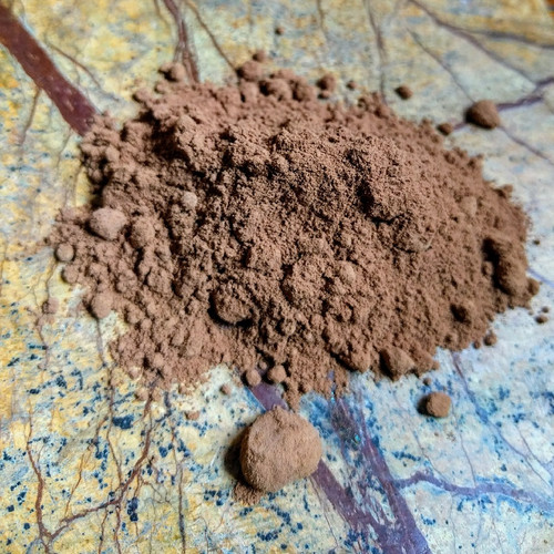 Natural cacao powder over marble stone