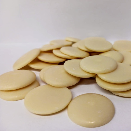 Cocoa Butter discs wafers light yellow on white background