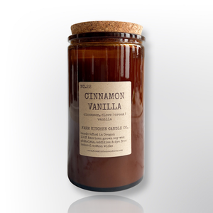 Handcrafted by Farm Kitchen Candle Co. Cinnamon Vanilla scented pure soy candle in a tall amber apothecary jar with a cork top.