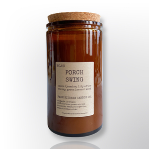 Handcrafted by Farm Kitchen Candle Co. Porch Swing scented pure soy candle in a tall amber apothecary jar with a cork top. Handcrafted by Farm Kitchen Candle Co. Porch Swing scented pure soy candle in a tall amber apothecary jar with a cork top.