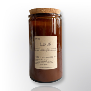 Handcrafted by Farm Kitchen Candle Co. Linen scented pure soy candle in a tall amber apothecary jar with a cork top.