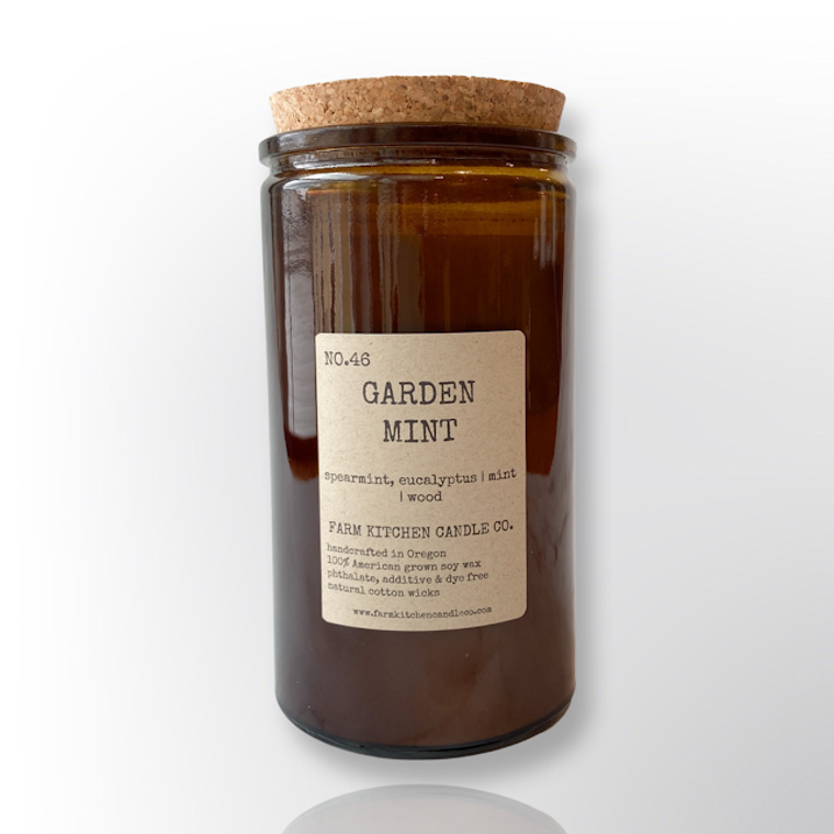 Handcrafted by Farm Kitchen Candle Co. Garden Mint scented pure soy candle in a tall amber apothecary jar with a cork top.