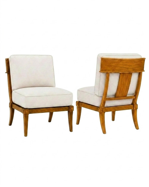 Two sophisticated teak Klismos outdoor chairs positioned to showcase the splayed legs and coastal resort aesthetic.
