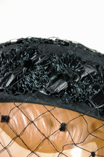 Black fabric and raffia straw mini pillbox hat 1960s with polka dot veil flat crown