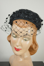Black fabric and raffia straw mini pillbox hat 1960s with polka dot veil flat crown