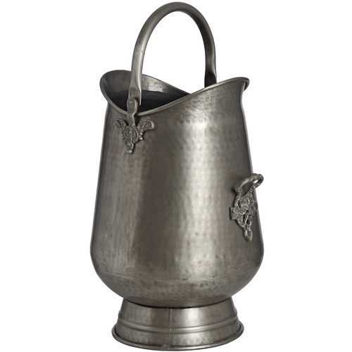 Antique pewter coal bucket with hammered texture, arched handle and ornate scrollwork handle mounts on white background