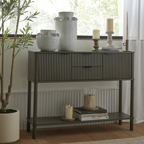 Reed 2 Drawer 2 Door Console styled by a window with vases, books, and candles