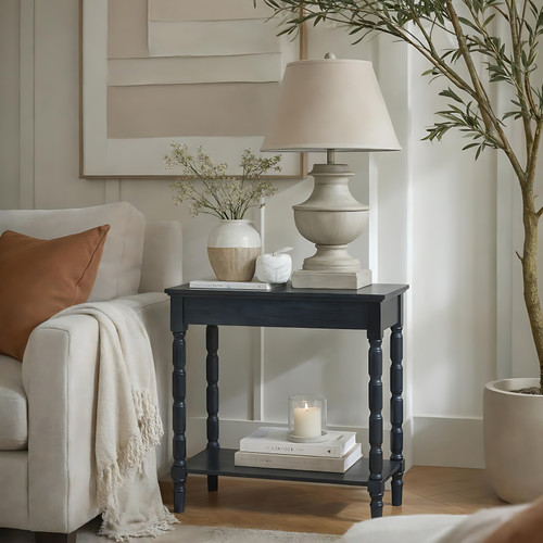 Contour Console styled in a living room with a table lamp, vase, and books