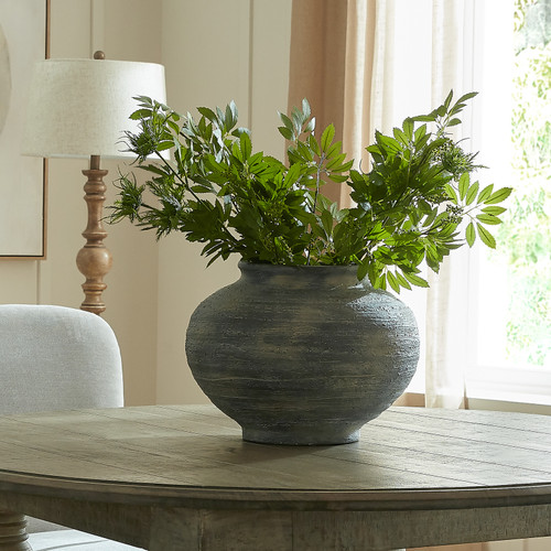 Marra Squat Vase styled with green foliage on a dining table