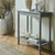 Serene Rattan Console Table styled in a hallway with candles and a ceramic vase