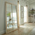Washed Wood XL Window Mirror leaning against a wall in a bright dining and living space