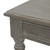 Close-up of the Serene Rattan Coffee Table's tabletop corner and turned leg