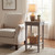 Serene Rattan Small Side Table styled beside an armchair with a lamp and basket