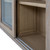 Close-up of the Delphine Sliding Glass Dresser Top's sliding door track and internal shelving