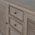 Close-up of the Delphine 2 Door 4 Drawer Large Dresser Base's drawer fronts and brass knobs