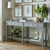 Serene 4 Drawer Console Table styled beneath framed botanical prints, with a lamp and vases on top