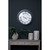 Bloomsbury Wall Clock styled on a dark wall above a console table with vases and lanterns