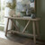 Haldon whitewashed trestle-leg console table styled with vases and books