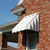 Retro aluminum awning accentuating a window with its timeless design and durable construction.