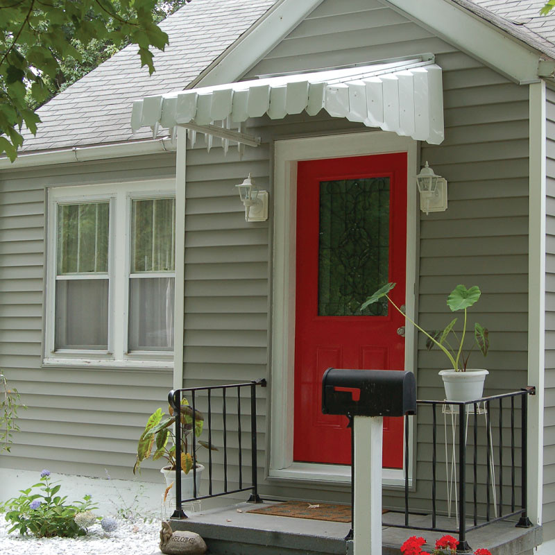 Retro aluminum awning accentuating a door with its timeless design and durable construction.