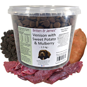 A tub of Britten and James complete grain free dog food with ingredients around it; venison, sweet potato and mulberries