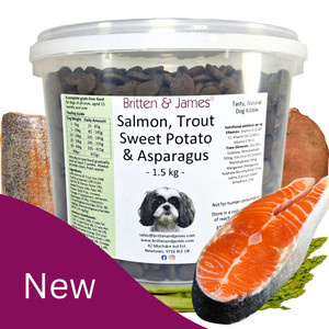 A tub of Britten and James complete grain-free dog food with ingredients around it; Salmon, Trout, Sweet Potato and Asparagus.  On the bottom left is a purple shape with 'New' in white text A tub of Britten and James complete grain-free dog food with ingredients around it; Salmon, Trout, Sweet Potato and Asparagus.  On the bottom left is a purple shape with 'New' in white text