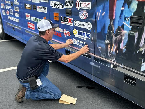 DuraMark employee installing a decal