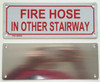 FIRE HOSE IN OTHER STAIRWAY  Compliance sign