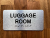 The Luggage Room with Raised Letters & Grade 2 Compliance Sign