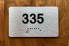 Apartment number 335 Ada Sign