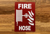 fire-hose-sign-red-equipment-notice.jpg