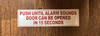red-push-until-alarm-sounds-door-can-be-opened-in-15-seconds-screw-mount-sign.jpg