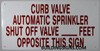 CURB VALVE AUTOMATIC SPRINKLER SHUT OFF VALVE_ FEET OPPOSITE THIS   BUILDING SIGN