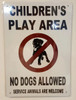 building sign CHILDREN’S PLAY AREA - NO DOGS ALLOWED SERVICE ANIMALS ARE WELCOME - WHITE BACKGROUND