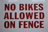 Building NO BIKES ALLOWED ON FENCE  sign