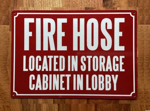 NYC FIRE HOSE LOCATED IN STORAGE CABINET IN LOBBY SIGN