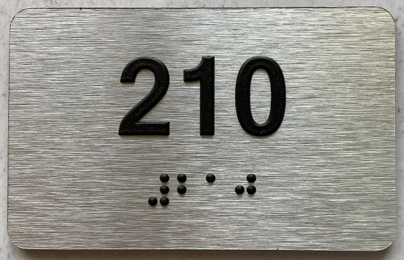 apartment number 210 sign