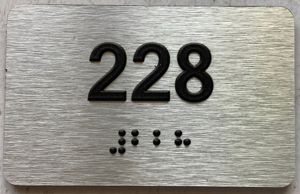 apartment number 228 sign