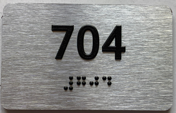 apartment number 704 sign