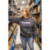 Woman in warehouse wearing a black hoodie with van cafe logo