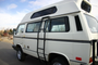 White VW Vanagon with rocky mountain westy side ladder installed