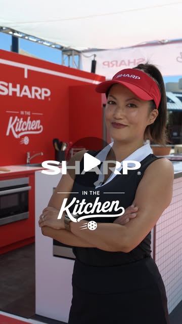 Woman wearing a red Sharp visor at the red Sharp In the Kitchen booth