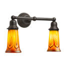 A reproduction Craftsman style bungalow two-light bathroom vanity fixture. It has an oil-rubbed bronze finish and illuminated,  trumpet-shaped blown glass shades with a feather pattern. 