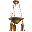 A traditional, Victorian transitional Craftsman style chandelier with an aged finish and three lanterns. The lanterns have trumpet shaped blown glass shades with a poppy design.