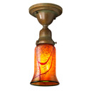  A traditional, Victorian transitional Craftsman style ceiling light fixture with a patina finish and an illuminated, trumpet-shaped blown glass shade with a cherry blossom design.