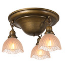 A traditional, Victorian transitional Craftsman style ceiling light fixture with an aged finish and three hanging lanterns. The lanterns have scalloped glass shades with an Art Deco design.