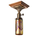  An Arts & Crafts, semi-flush ceiling mounted lantern with an aged brass finish, a turn key socket and cylindrical, blown glass red feather shade. The ceiling plate is Stickley-inspired quarter sawn oak.